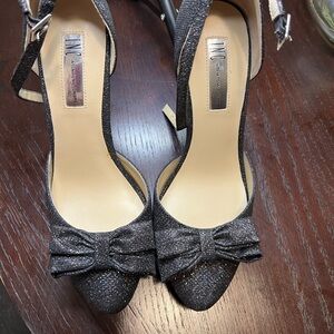 Black glitter pointed heels with bow